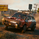 Jackie Wells drives a car in the desert navigating Night City in Cyberpunk 2077 patch 1.5.